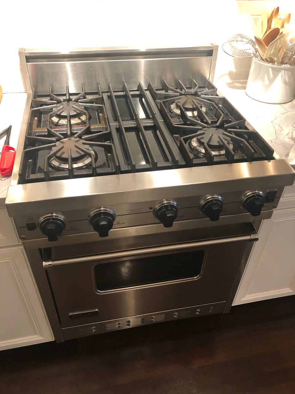 Sub-Zero appliance repair in Miami — Viking professional 4-burner gas range in a luxury Miami kitchen alongside the Sub-Zero lineup we service